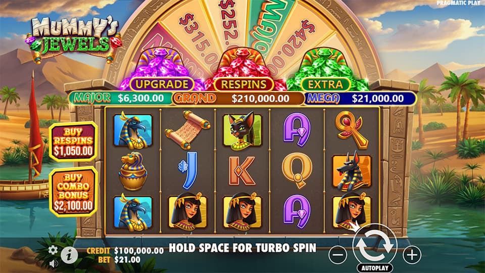 Mummy's Jewels slot grid with Egyptian gods, queens, ankhs and gem wheel in desert background.