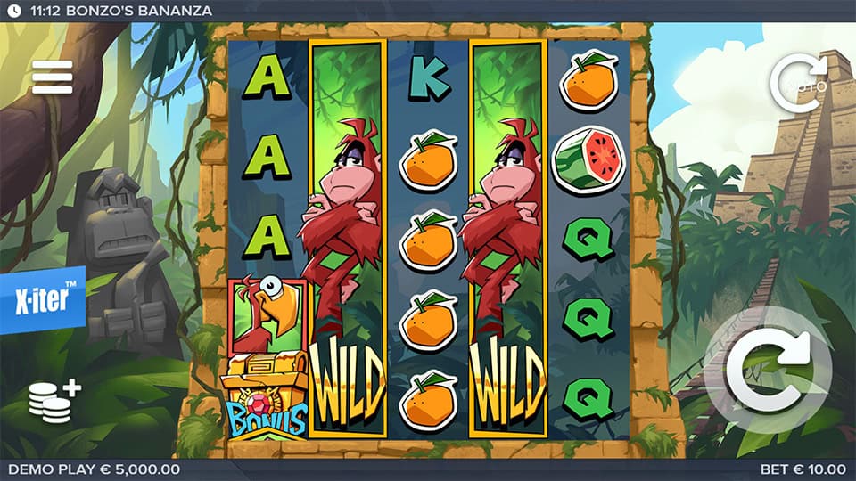 Jungle-themed reels packed with oranges, parrots, letters, and stacked monkey wilds, framed by stone ruins and tropical foliage.